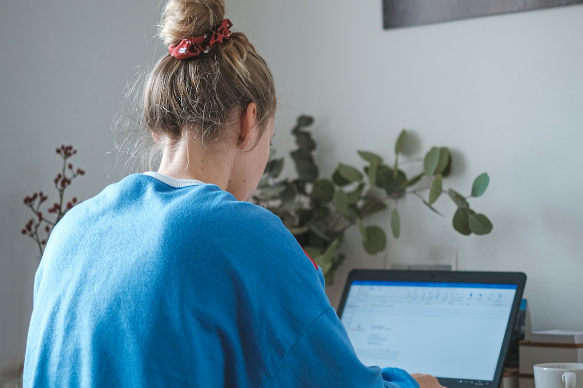 A person at a laptop during a video call